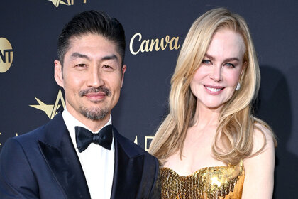 Brian Tee and Nicole Kidman pose on the red carpet together honoring nicole kidman