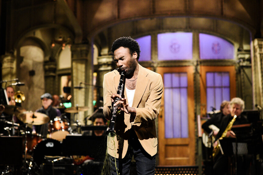 Host Donald Glover plays clarinet during his SNL opening monologie