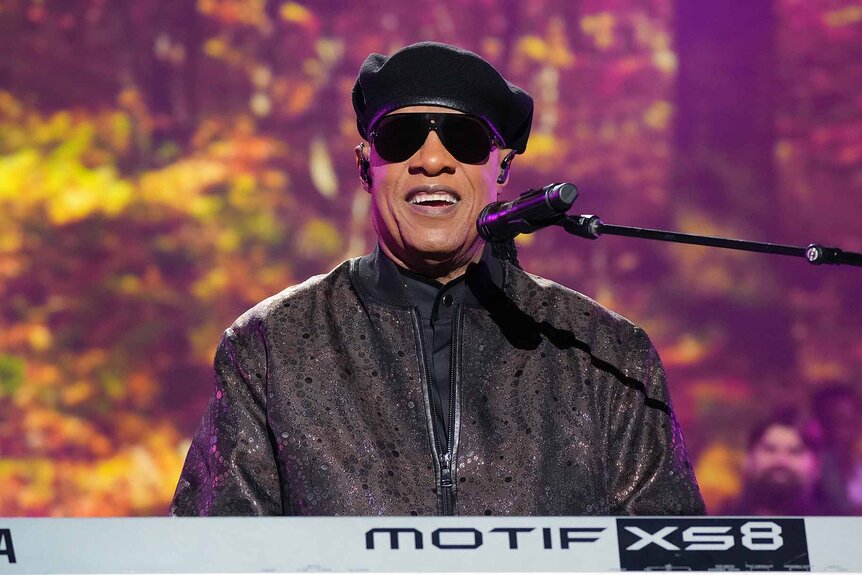 Stevie Wonder smiles as he performs onstage.