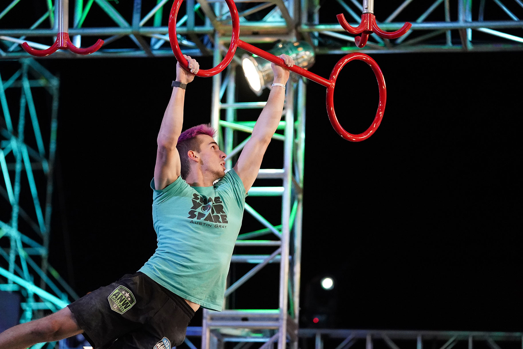 Contestant swnging on a ninja warrior obstacle