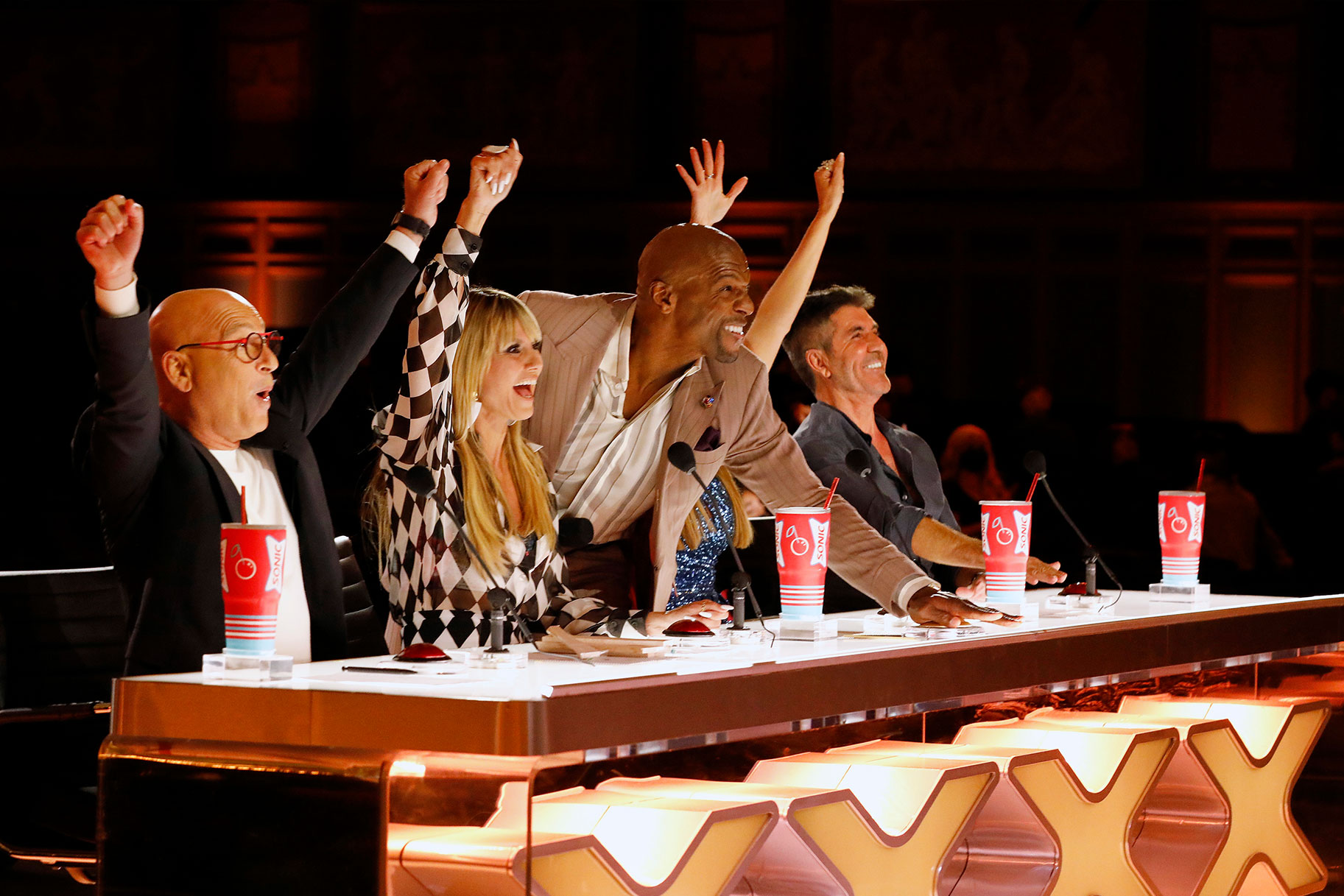 Americas Got Talent judges cheering on a performer with the arms in the air