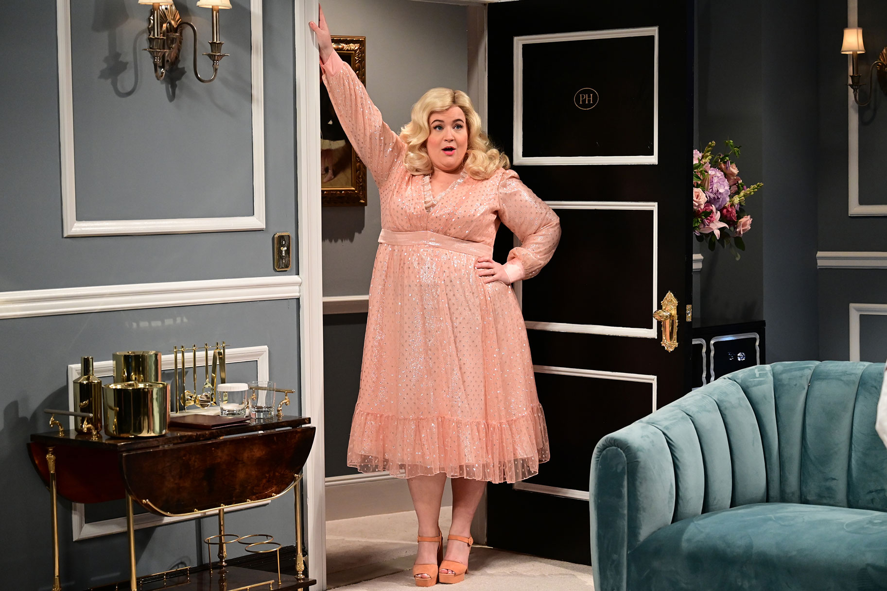 Aidy Bryant leaning against a door frame