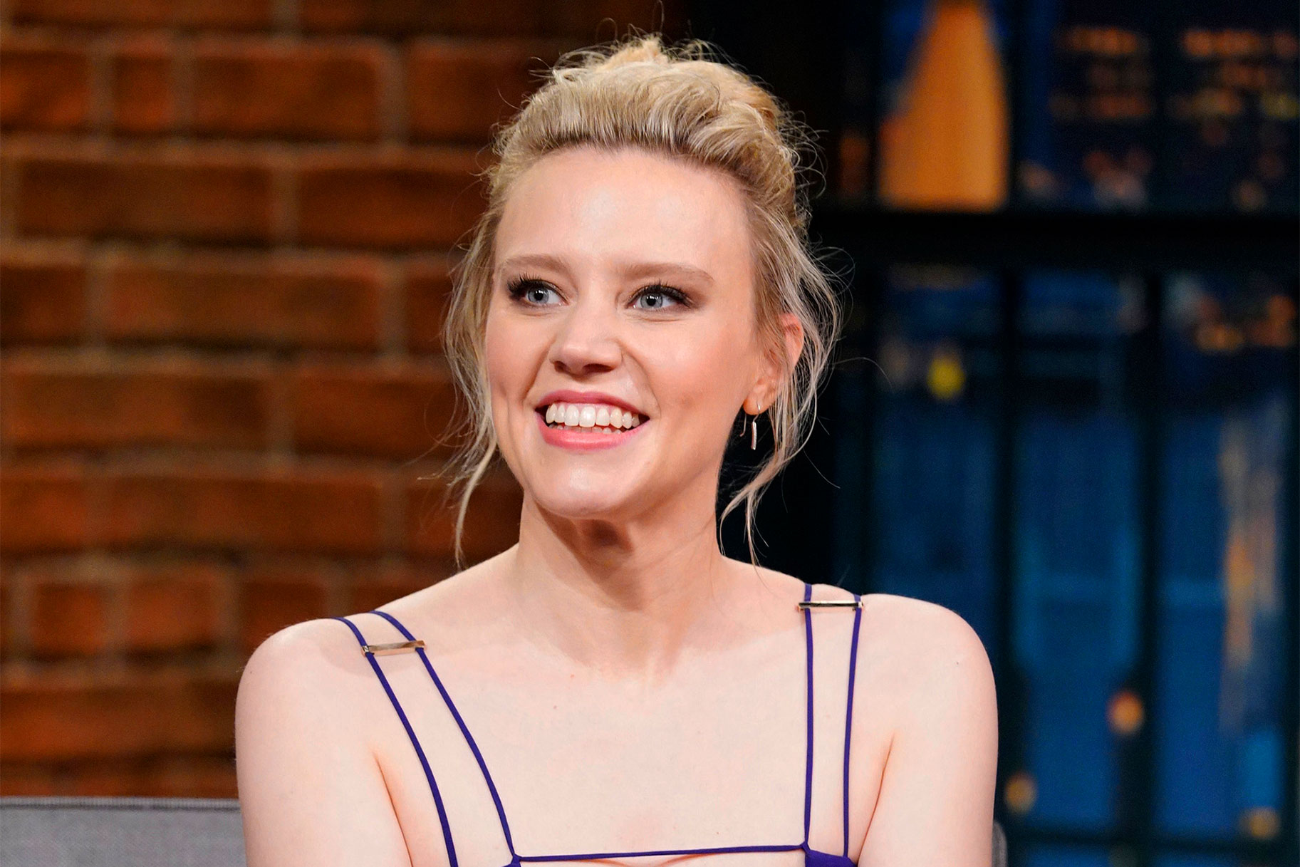 Kate McKinnon smiling and looking off camera