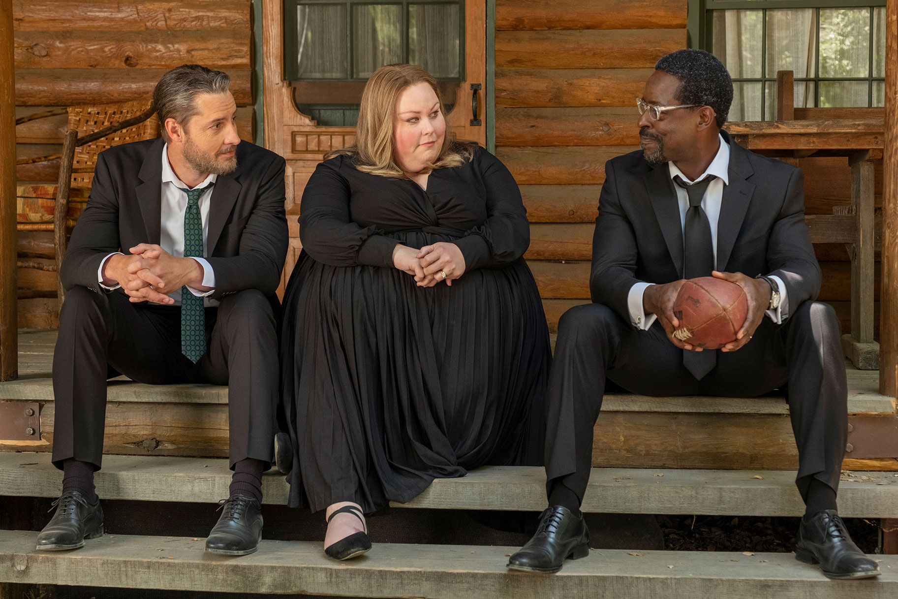 Justin Hartley, Chrissy Metz, and Sterling K. Brown sitting together on a porch