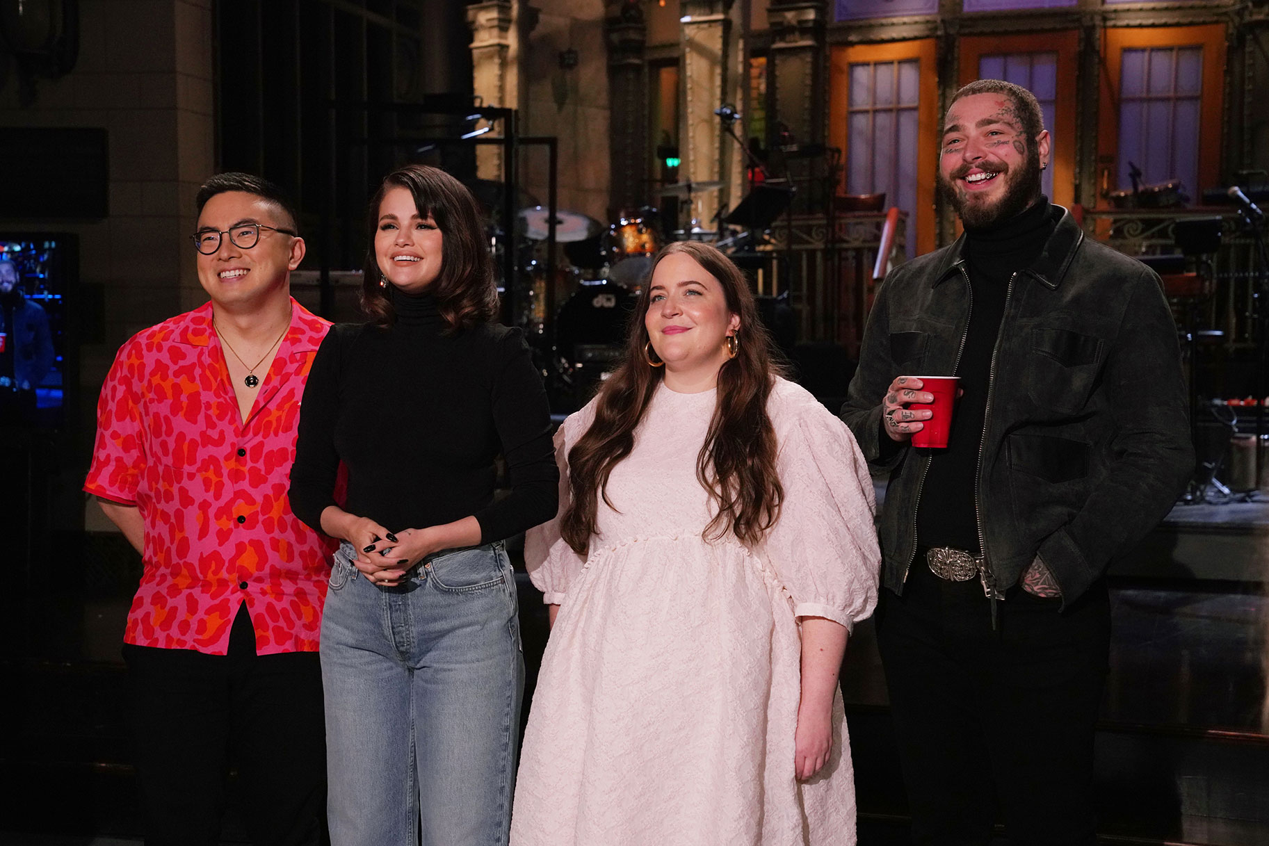 Bowen Yang, Selena Gomez, Aidy Bryant, and Post Malone standing on the SNL stage