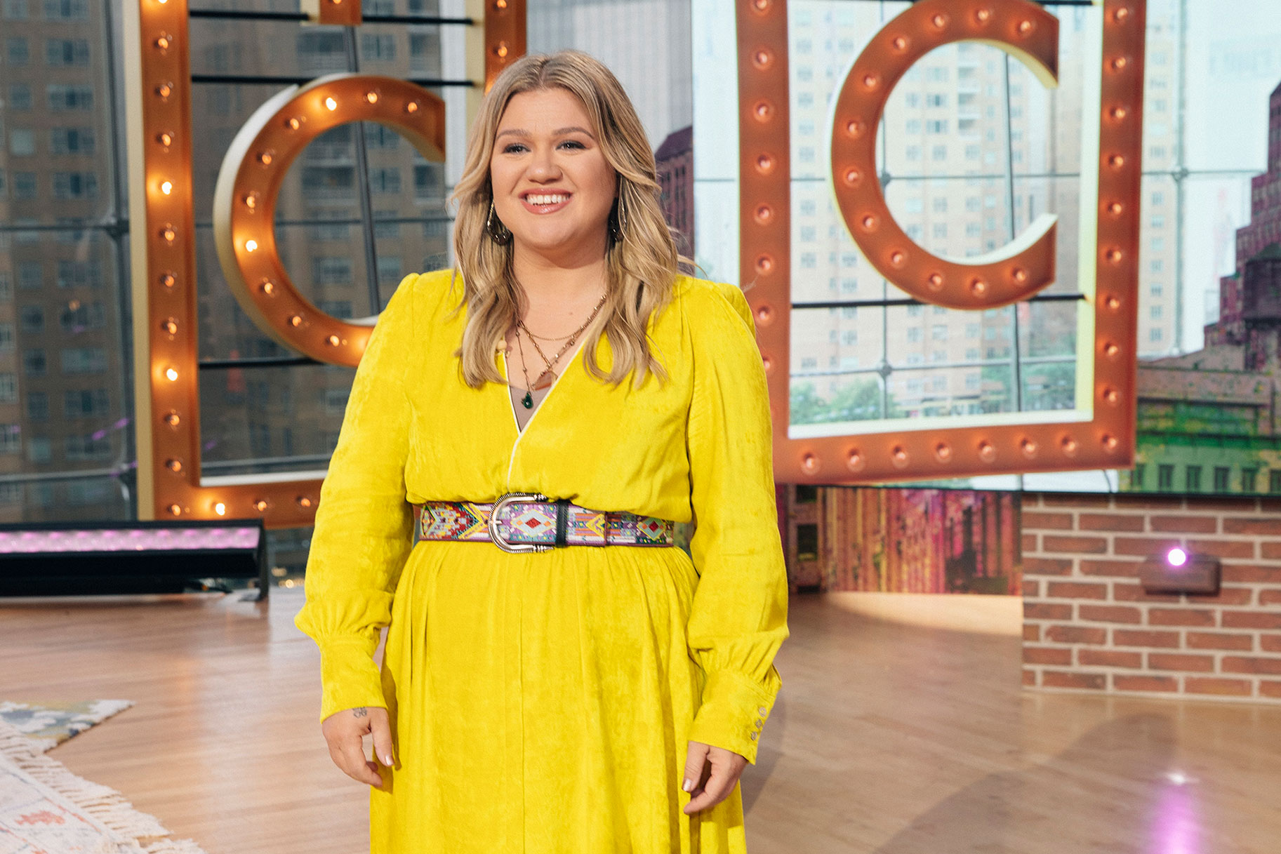 Kelly Clarkson smiling on the set of her talk show