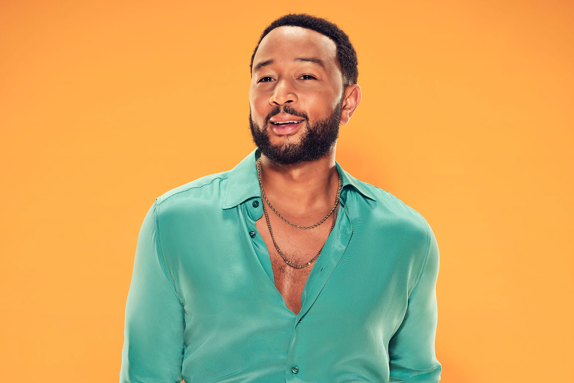 John Legend posing with a smirk on his face