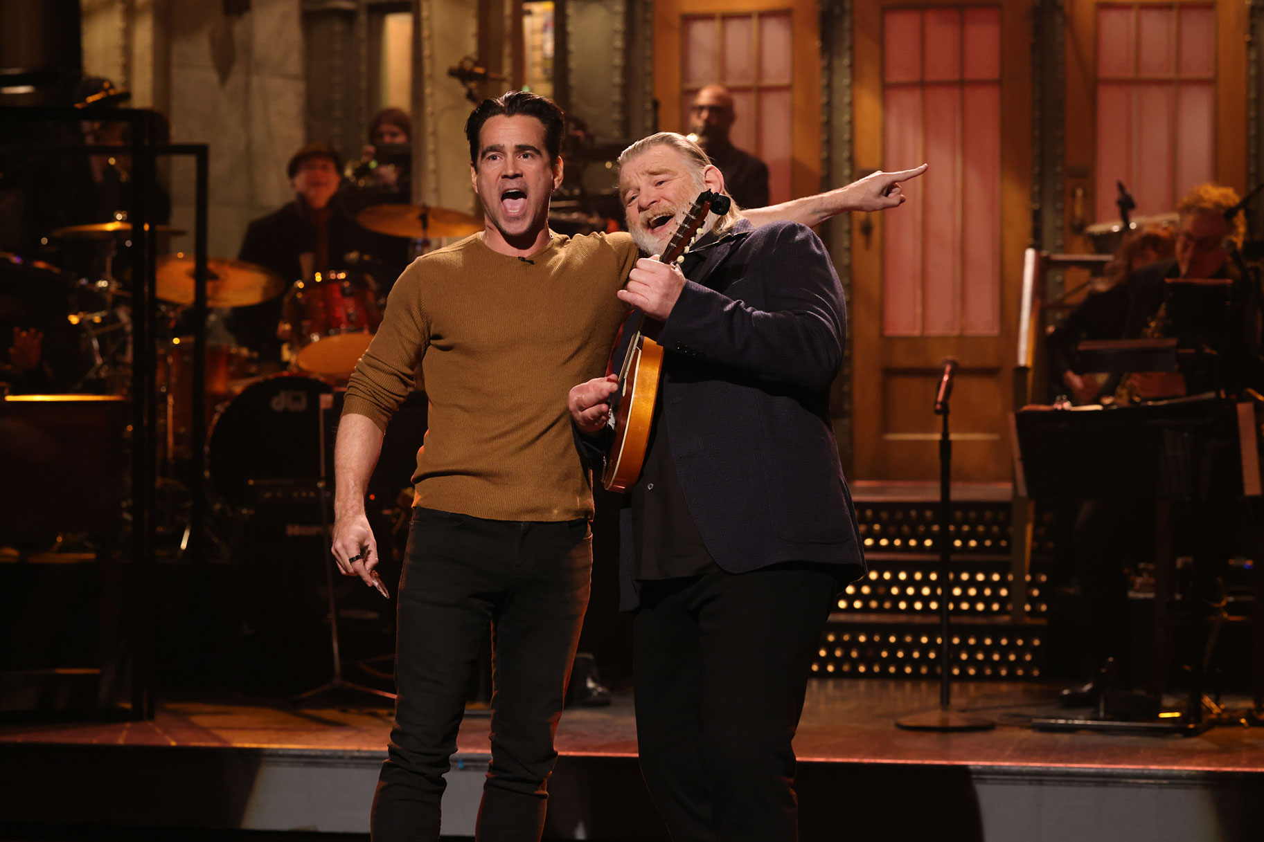 Brendan Gleeson and Colin Farrell embrace on the SNL stage