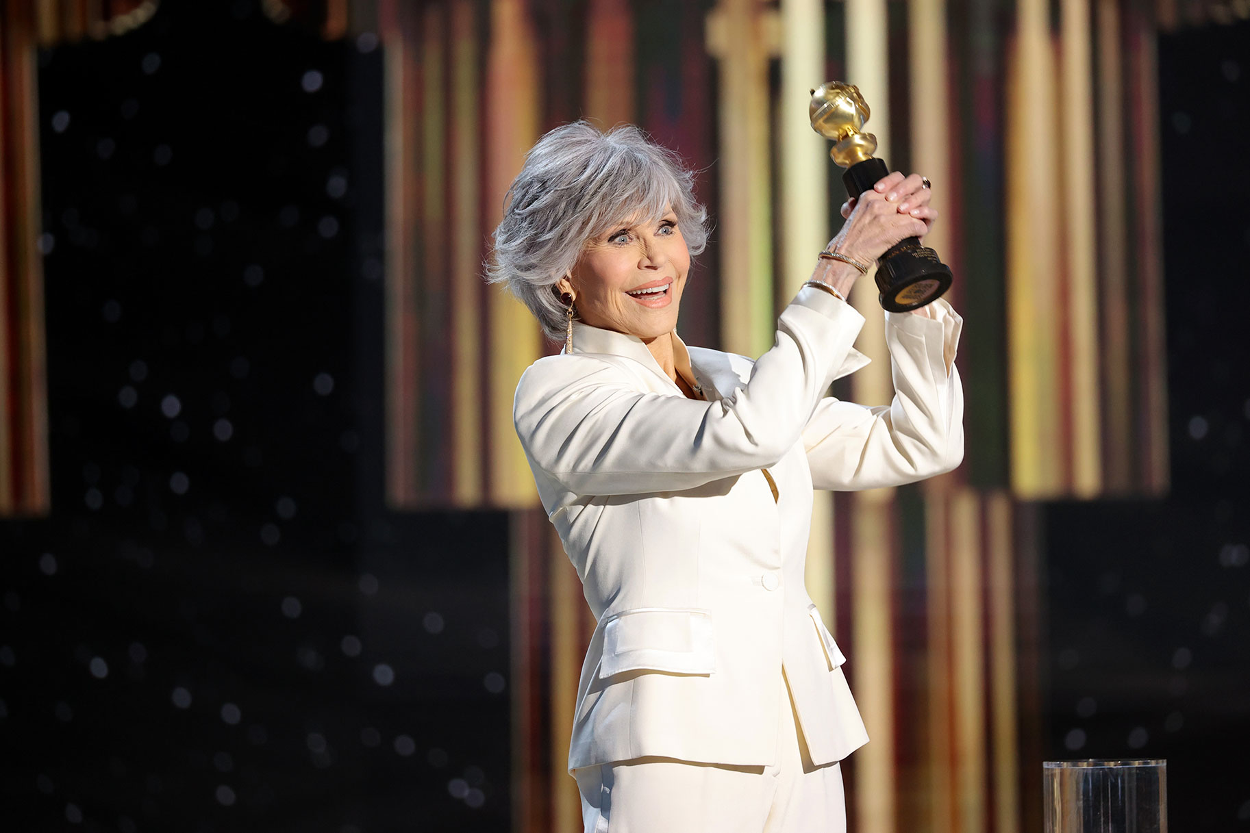 Jane Fonda holding a Golden Globe onstage