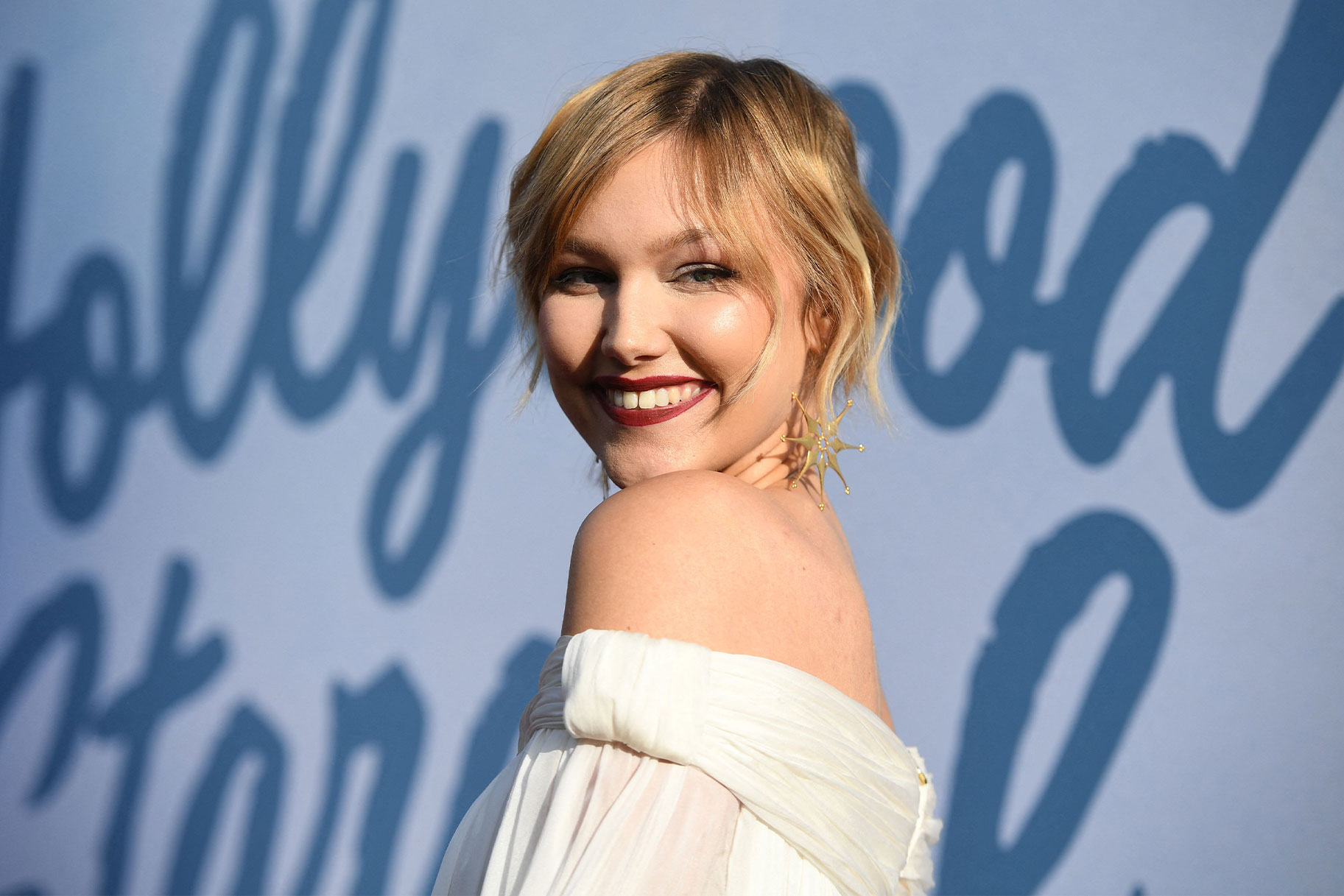 Grace Vanderwaal smiling at the camera on a red carpet