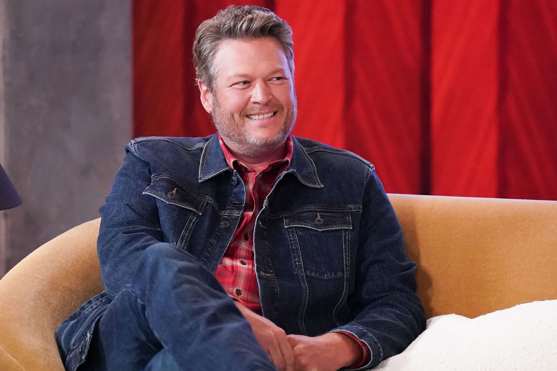 Blake Shelton sitting and smiling