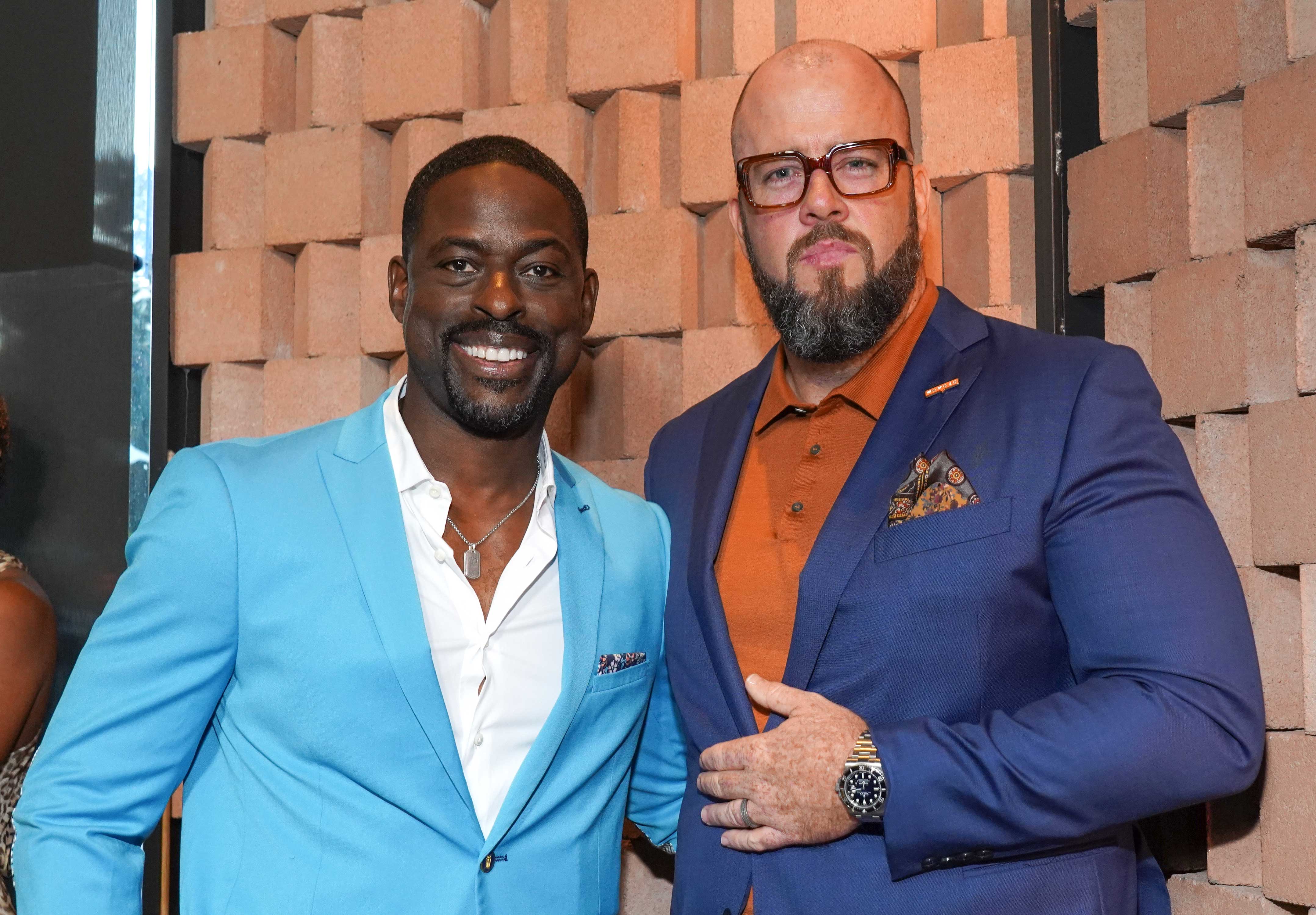 Chris Sullivan and Sterling K. Brown wearing blue suits at an event.