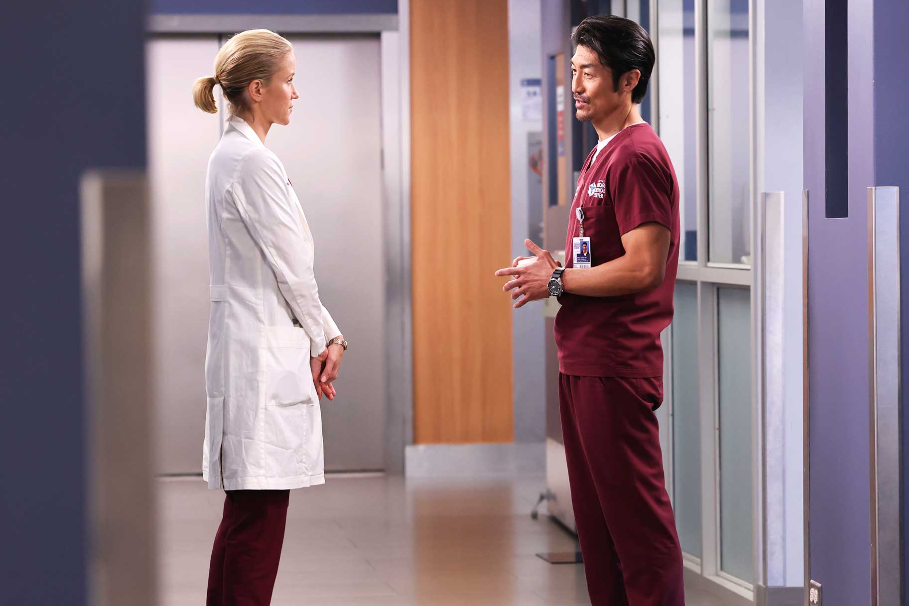 Hannah Asher (Jessy Schram) and Ethan Choi (Brian Tee) standing face to face on the set of Chicago Med.