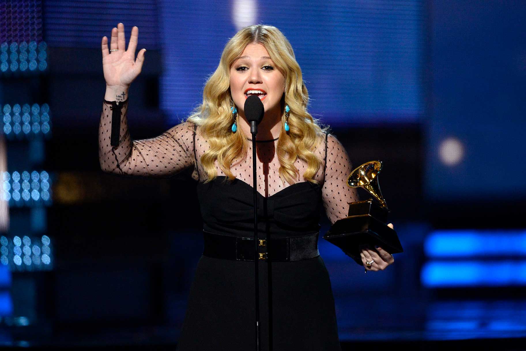 Kelly Clarkson talking on stage at the 55th Annual Grammy Awards.