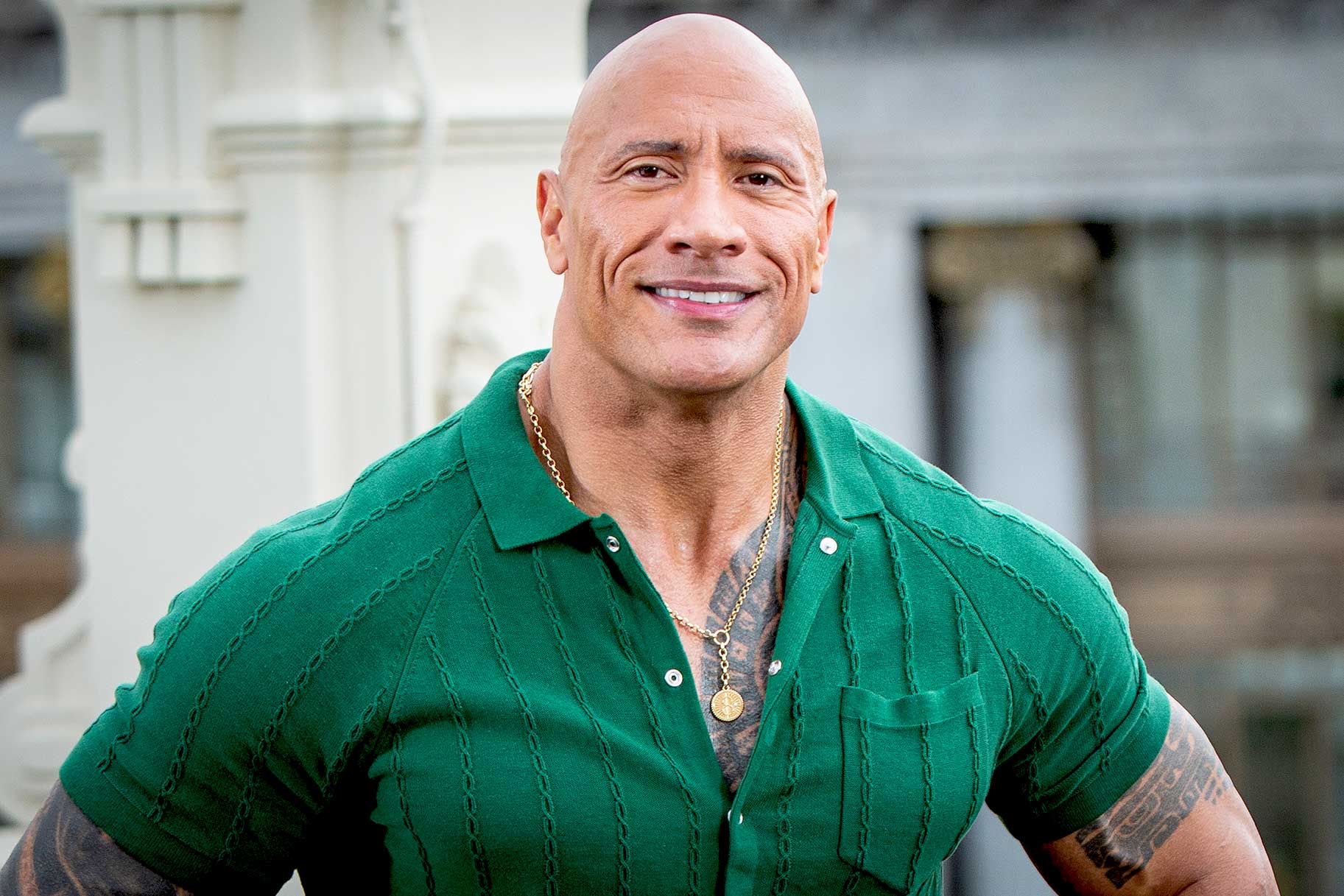 Dwayne Johnson appears at an event wearing a green shirt.