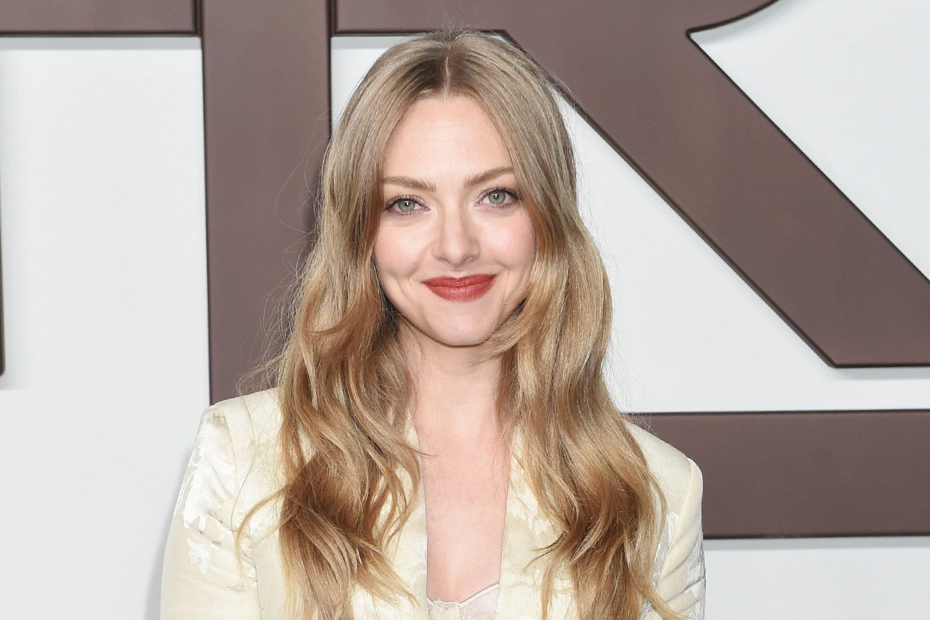 Amanda Seyfried attends the ralph lauren fashion show smiling in red lipstick