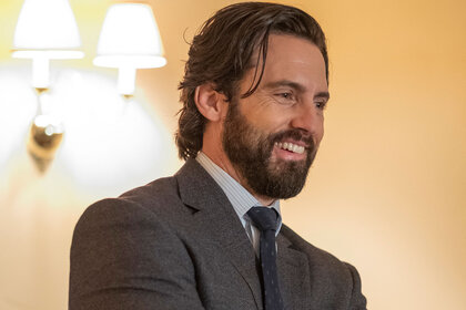 Milo Ventimiglia as Jack Pearson, smiling while wearing a grey suit