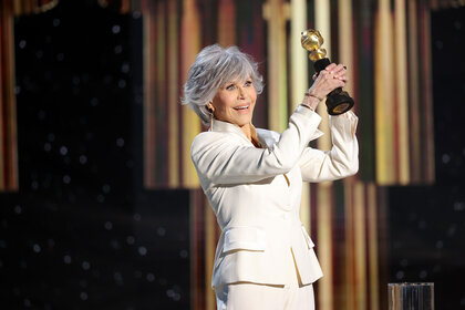 Jane Fonda holding a Golden Globe onstage