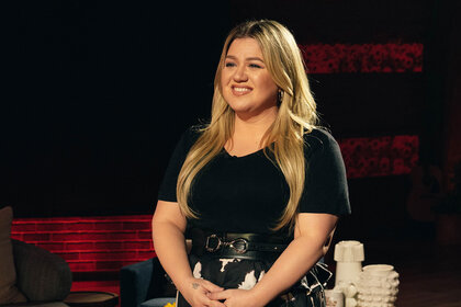 Kelly Clarkson smiling and looking off camera
