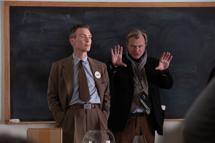 Cillian Murphy (as J. Robert Oppenheimer) and writer, director, and producer Christopher Nolan on the set of OPPENHEIMER.