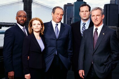 A.D.A. Ron Carver, Detective Alexandra Eames, Dick Wolf, Detective Robert Goren, Captain James Deakins appear in a promotional photo for Law & Order: Criminal Intent.