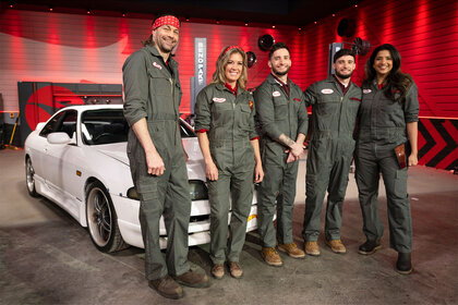 A crew poses in front of their car during episode 9 of Hot Wheels: Ultimate Challenge