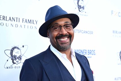 Jesse L. Martin in a blue suit and hat attending the Barbara Berlanti Heroes Gala.