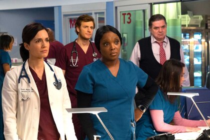 Dr. Natalie Manning, Maggie Lockwood, Dr. Will Halstead, and Dr. Daniel Charles standing next to each other in a scene from Chicago Med.