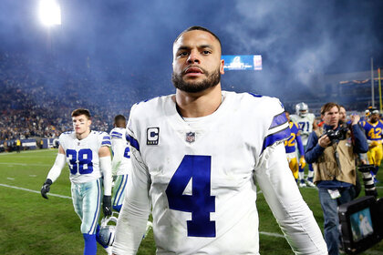 Football player Dak Prescott #4 of the Dallas Cowboys on the football field after a game