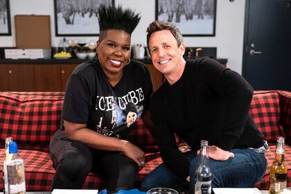 Leslie Jones and Seth Meyers smiling and posing