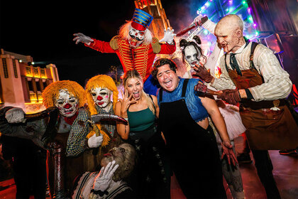 Ariana Madix poses with costumed characters from Halloween Horror Nights