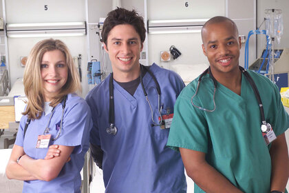 Actors Sarah Chalke, Zach Braff, and Donald Faison poses for a publicity photo for the television show "Scrubs."