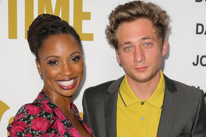Shanola Hampton and Jeremy Allen White smile together on the red carpet