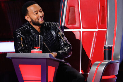 John Legend sits in his chair