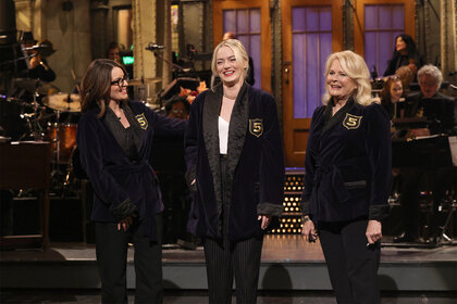 Tina Fey, Emma Stone and Candice Bergen stand on stage during saturday night live episode 1850