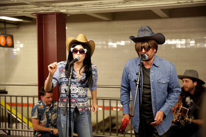 Miley Cyrus and Jimmy Fallon wear disguises as they perform in the New York City subway