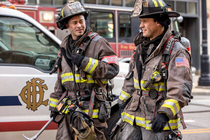 Kelly Severide (Taylor Kinney) and Matthew Casey (Jesse Spencer) in their firefighting uniforms