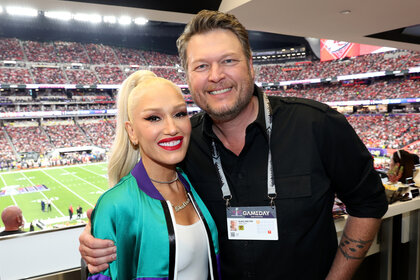 Gwen Stefani and Blake Shelton embrace and smile together during the 2024 Super Bowl