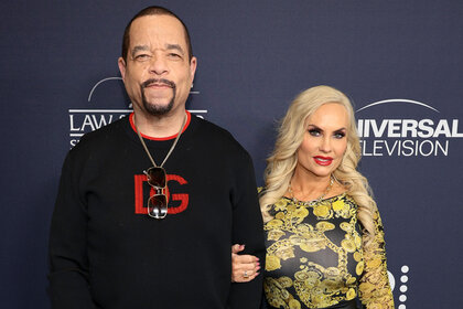 Coco Austin holds Ice T's arm on the red carpet for aw & Order: Special Victims Unit 25th Anniversary Celebration
