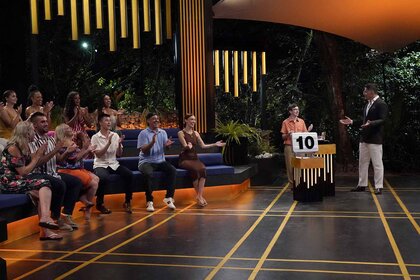 The cast of Deal or No Deal Island participate on a set in Episode 101.