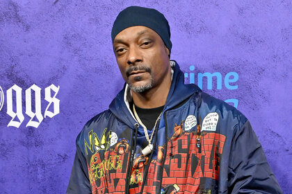 Snoop Dogg wears a hoodie on the red carpet for the World Premiere The Underdoggs