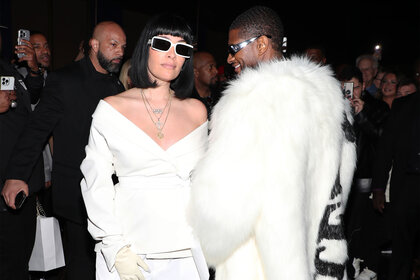 Jennifer Goicoechea and Usher wear all white and sunglasses while posing for a photo together