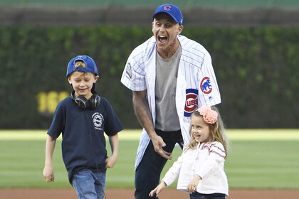 David Eigenberg with his children throw the first pitch the Chicago Cubs game