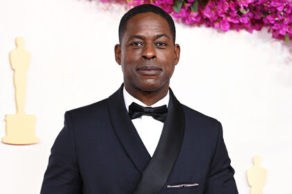 Sterling K. Brown smiles on the red carpet at the 2024 Oscars