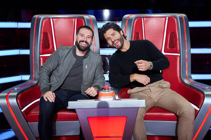 Dan + Shay sit in their coaches chairs on The Voice 2508