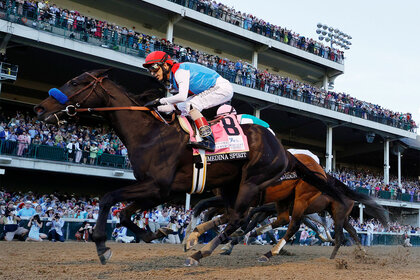 Medina Spirit and John Velazquez cross the finish line to win the 147th running of the Kentucky Derby
