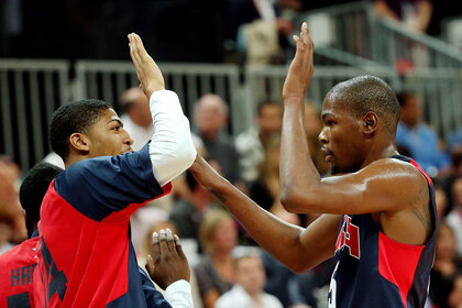 Anthony Davis and Kevin Durant high five during the Men's Basketball Preliminary Round match on Day 10 of the London 2012 Olympic Games