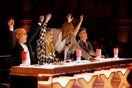 Americas Got Talent judges cheering on a performer with the arms in the air