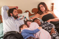 Jack and Rebecca laying down with their kids laying between them