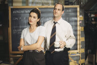 Olivia Benson stands with Elliot Stabler in front of a chalkboard